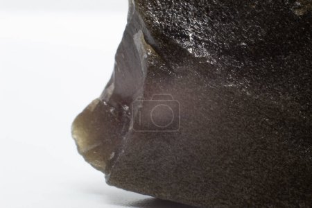 Silver sheen textured obsidian volcanic glass chunk isolated on a white background surface macro close up