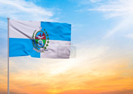 3D illustration of a Rio de Janeiro flag extended on a flagpole and in the background a beautiful sky with a sunset