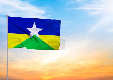 Photo for 3D illustration of a Rondonia flag extended on a flagpole and in the background a beautiful sky with a sunset - Royalty Free Image