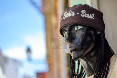Face of a mannequin in black clothing with a cap of the Olodum of Salvador Bahia