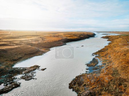 Photo for Bright blue river trough Iceland mainland in autumn time on a cold day. High quality photo - Royalty Free Image