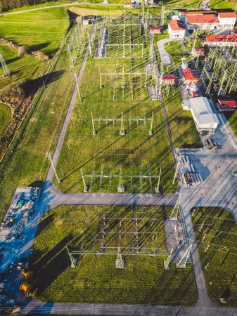 Foto de Electrical power substation in the country side of Slovenia. Fields and forests surrounding the power station in the suburbs. Aerial view. - Imagen libre de derechos
