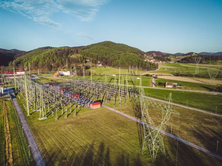 Foto de Electrical power substation in the country side of Slovenia. Fields and forests surrounding the power station in the suburbs. Aerial view. - Imagen libre de derechos