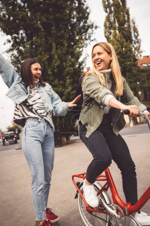 Photo for Two young caucasian women having fun on city street outdoors - Best friends enjoying a holiday day out together - Happy lifestyle, youth and young females concept. High quality photo - Royalty Free Image