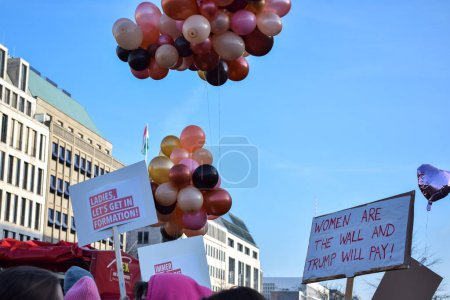 Photo for BERLIN, GERMANY - 19.01.2018: Several feminist protesters participate in a protest against gender violence holding pink balloons and banners in commemoration of March 8 in Madrid - Royalty Free Image