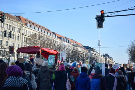 Photo for BERLIN, GERMANY - 19.01.2018: Girl give a speech in front of feminist protesters in a feminist demonstration caravan against gender violence and in commemoration of March 8 - Royalty Free Image