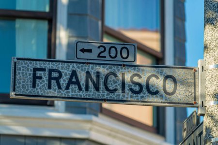 Photo for Black and white sign that says Francisco in the historic districts of san francisco california in midday shade. Dense suburban background with visible sun streaks in the downtown city neighborhoods. - Royalty Free Image