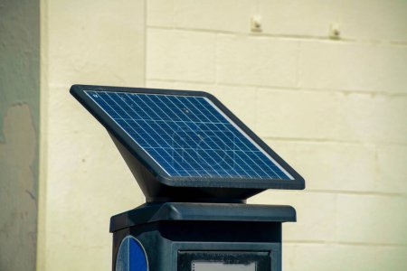 Parking pass kiosk in downtown urban area of city neighborhoods with solar pannel for cultivating green energy. Smart city design for combating climate change in middle class suburban urban area.