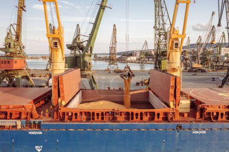 Cose up Black Sea port ukranian grain Loading process of dry cargo ship by harbor cranes. shallow depth of field