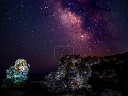 Photo for Travel to Bulgaria. The Milky Way galaxy moving over the rocky arch near Tyulenovo and Black sea. Night mindfulness Bulgaria - Royalty Free Image