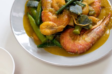 Photo for Ginisang gulay with hipon at kalabasa. Sauteed vegetables with shrimp and pumpkin. - Royalty Free Image