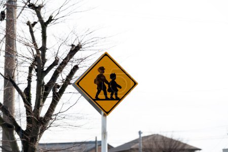 Children and students crossing road sign.