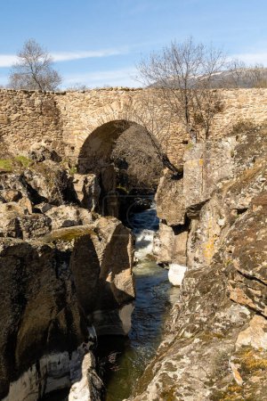 Photo for Matafrailes medival bridge over the Lozoya river in the Sierra de Guadarrama, Madrid, Spain - Royalty Free Image