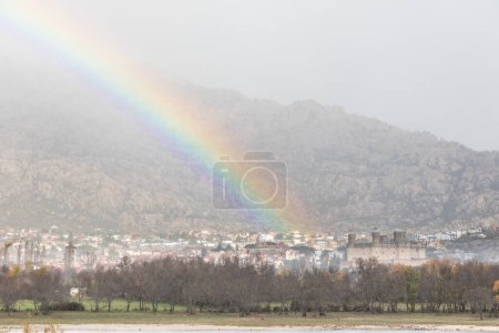Photo for Arcoiris in the Santillana reservoir and the city of Manzanares el Real in Madrid - Royalty Free Image