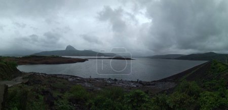 Photo for Panoramic landscape view of scenic Pawna lake on a rainy day. It is a famous picturesque tourist place located in Lonavala in Pune district of Maharashtra, India - Royalty Free Image