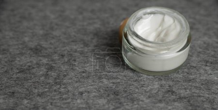 Photo for Skincare jar with cosmetic anti aging cream on gray surface - Royalty Free Image