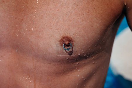 Photo for Man with nipple piercing at the swimming pool. High quality photo - Royalty Free Image
