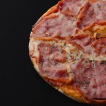 Delicious pizza prosciutto with ham and mozzarella. High quality photo