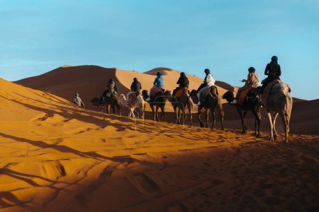 Photo for Group of people riding camels in the sahara desert, Merzouga. High quality photo - Royalty Free Image
