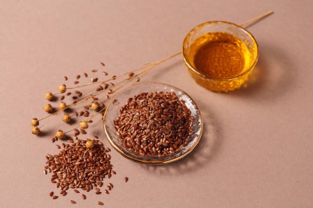 Brown linen seeds, flaxseed vegetable oil on beige background. Healthy super food
