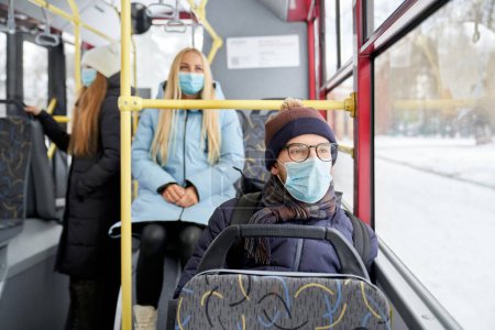 Foto de Portrait of passengers protecting themselves against coronavirus getting work home school. Ordinary day in public transport while covid spreading. Concept of nowadays reality while quarantine. - Imagen libre de derechos