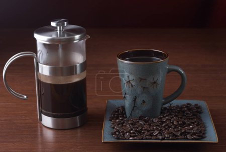  French press and a coffee cup