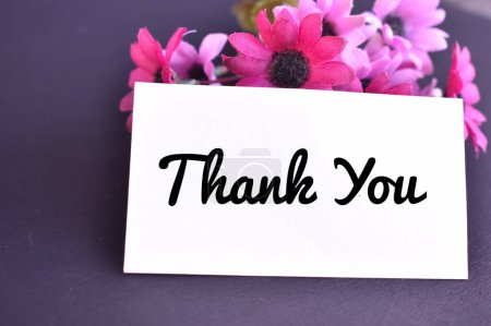 A closeup picture of a Thank you card with flowers