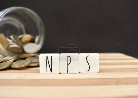 Photo for A closeup picture of NPS letters placed in front of coins splilled out of jar - Royalty Free Image