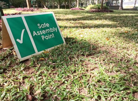 A selective focus picture of a board with Safe assembly point in large corporate campus for the safety of Employees during disaster.