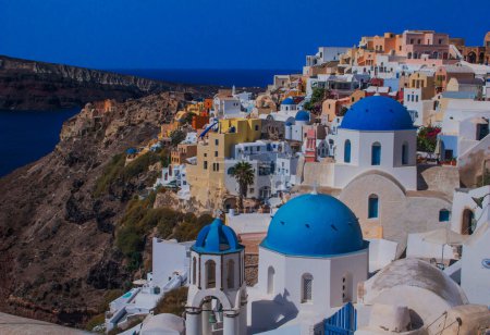 an overview of churches and houses in the town of Oia, island of Santorini, Greece