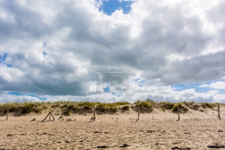 Téléchargez les photos : Scenic view of beach in Brittany France against dramatic summer sky - en image libre de droit