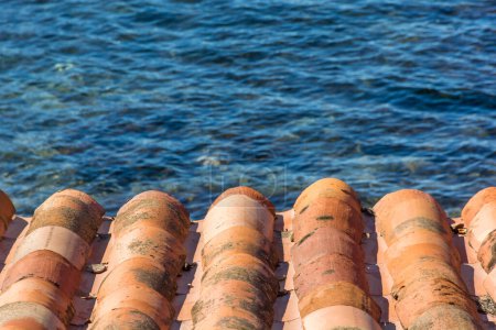 Photo for Scenic view of ceramic roof tiles against the Mediterranean sea in Saint Tropez bay area - Royalty Free Image