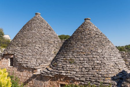 Photo for Scenic view of trulli whitewashed huts with conical roofs in Alberobello in Apulia in Italy - Royalty Free Image
