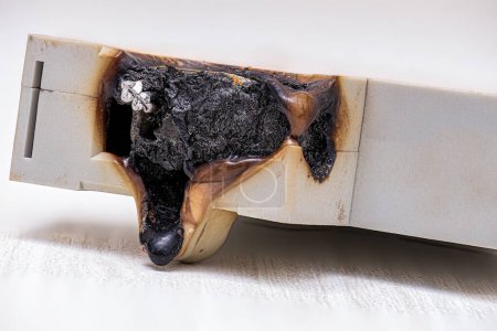 Foto de Fotografía macro de un disyuntor eléctrico quemado con plástico fundido - Imagen libre de derechos
