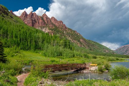 Photo for A beautiful scenic footbridge over West Maroon Creek beneath the famous Maroon Bells near Aspen Colorado. - Royalty Free Image