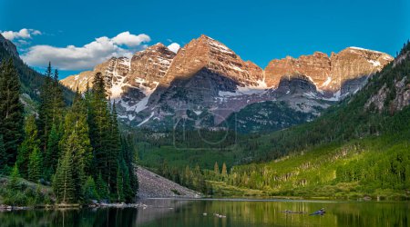 Photo for The Maroon Bells being lit by an early morning sun above the clear waters of Maroon Lake near Aspen, Colorado. - Royalty Free Image