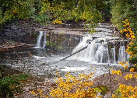 Photo for The Presque Isle River of the Upper Peninsula of Michigan is an autumn wonderland amidst the changing foliage and the numerous waterfalls and copper colored water. - Royalty Free Image
