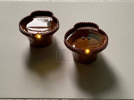 Photo for Plastic water lamp for karthigai deepam powered by battery that lights up an led bulb when we pour water in it connecting electrodes - Royalty Free Image