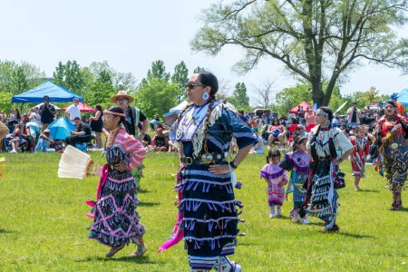 Photo for Pow Wow, Women traditional dance in Jingle Dress a healing or medicine dress. 2nd Annual Two Spirit Powwow, by 2-Spirited People of the 1st Nations: Toronto, Ontario, Canada - May 27, 2023. - Royalty Free Image
