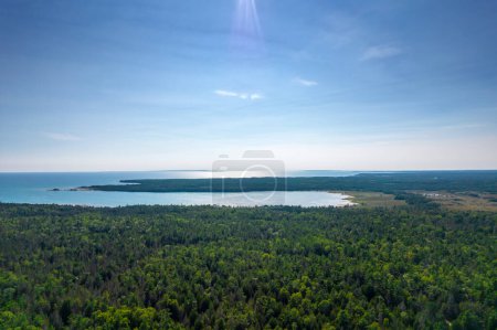 Misery Bay waters of lake Huron and green vegetation aerial view from above. Exploration of the diverse trails and wildlife. Harmony with nature. Spectacular views of Lake Huron. Great Canadian lakes.
