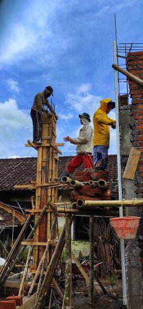 Téléchargez les photos : Magelang, Indonésie - Avril 07, 2022 : Personnes construisant une nouvelle maison dans la campagne asiatique. - en image libre de droit