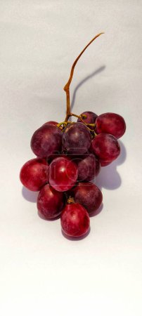 Photo for A bunch of red grapes in the concept photo has a shadow on the grapes - Royalty Free Image