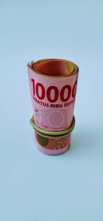 Photo for 100 thousand rupiah rolled using rubber - Royalty Free Image