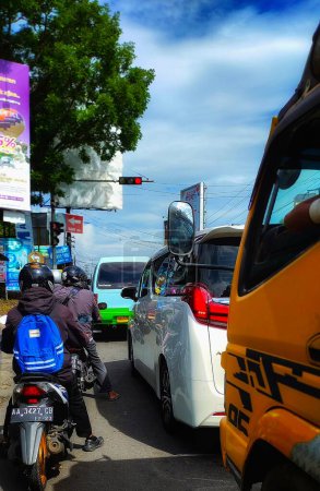 Photo for Magelang, Indonesia - Nov 2022: Photo of a queue of vehicles in front of a traffic light in Magelang, Central Java, Indonesia - Royalty Free Image