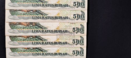 Photo for Indonesian banknotes Rp.500,00 rupiah issued in 1992. Old rupiah currency concept isolated on a black background. - Royalty Free Image