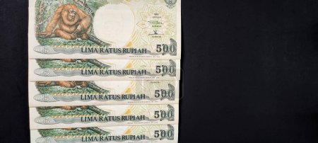 Photo for Indonesian banknotes Rp.500,00 rupiah issued in 1992. Old rupiah currency concept isolated on a black background. - Royalty Free Image