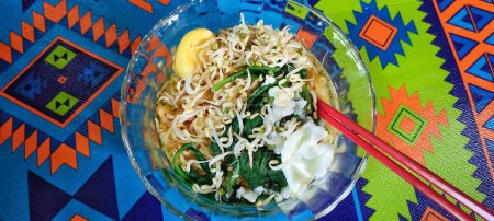 Photo for Indonesian noodle soup complete with vegetable toppings and boiled eggs on top. - Royalty Free Image