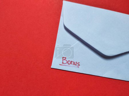 Photo for Top view of a white envelope isolated on a red background. - Royalty Free Image
