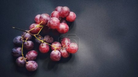 Photo for Top view of a sprig of grapes was photographed with the concept of giving a light effect to the grapes - Royalty Free Image