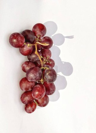 Photo for Portrait red grapes is photographed with a shadow concept on the photo object isolated on a white background - Royalty Free Image